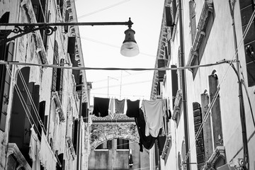 Naklejka premium Venetian street with drying clothes