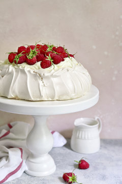 Meringue cake "Pavlova" with fresh ripe raspberry and whipped cream.