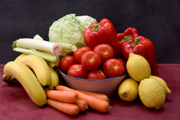 still life with tomatoes, peppers, lemons, carrots and lettuce