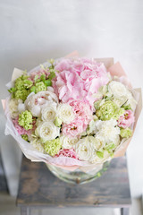 Floristry concept. Bouquet of beautiful flowers on gray table. Spring colors. the work of the florist at a flower shop.