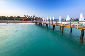 Beautiful scenery with wooden pier on Turkish Riviera at sunset, Side