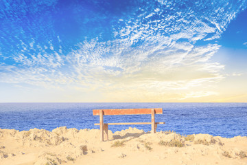 Beautiful view of a lonely bench over the sea