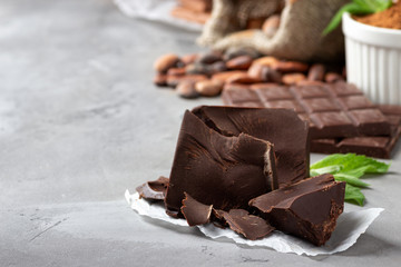 Cocoa and chocolate on gray stone background.