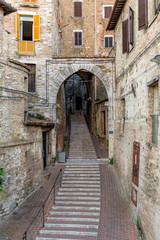 Fototapeta na wymiar Street with arch doorway in Italy