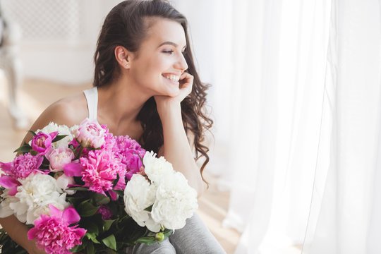 Young Attractive Woman With Flowers