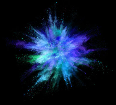 Explosion of coloured powder on black background