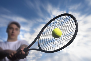 Tennis player hitting ball with backhand
