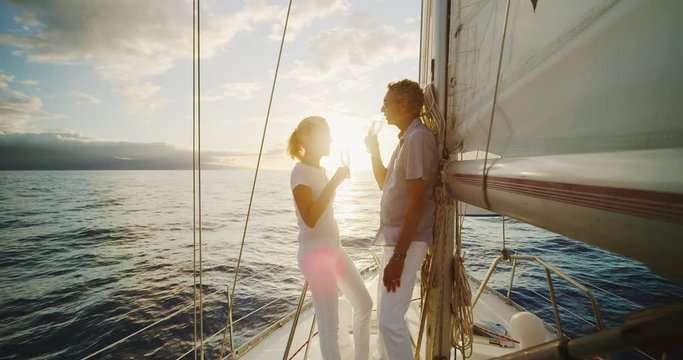Middle aged couple celebrating life, sailing into the sunset