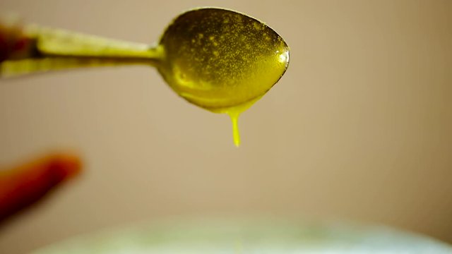Close up of woman hand poured the ghee and dripping