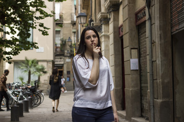 Women with a silence gesture on a city street