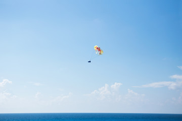 A shot of a parasail in the middle of the air over Cancun's beach.