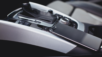 smartphone with dual camera in the interior of a modern car