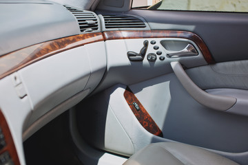 Old luxury modern car interior, beige color, electronic buttons, automatic transmission lever