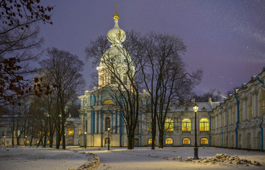 Snowfall and Smolny Convent with night illumination in St. Petersburg, Russia.