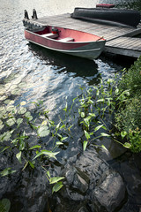 Boat at dock on small lake