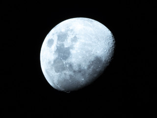 Half Moon, Crescent moon, gibbous moon in the middle of its way on the clear sky.