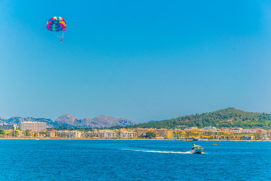 A tourist is enjoying parasailing at Alcudia bay, Mallorca, Spain