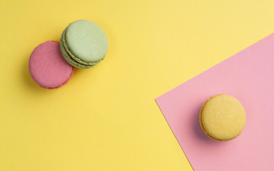 french macaroons on yellow and pink corner background