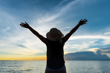 Fototapeta premium People freedom concept. Young woman relaxing in summer sunset sky outdoor.