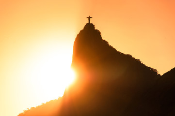 The famous Rio de Janeiro landmark - Christ the Redeemer statue on Corcovado mountain. Silhouette by sunset