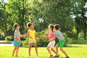 Naklejka premium Cute children playing with ball in park