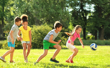 Naklejka premium Cute children playing with ball in park