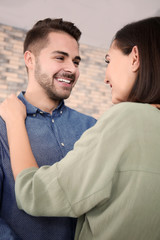 Beautiful young couple dancing indoors