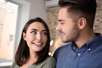 Fototapeta premium Beautiful young couple dancing indoors
