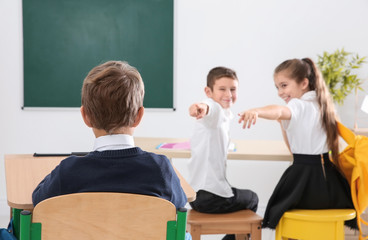 Children bullying their classmate in school