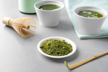 Plate with powdered matcha tea and chashaku on table