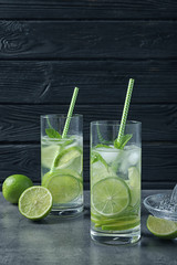 Glasses of natural lemonade with lime on table