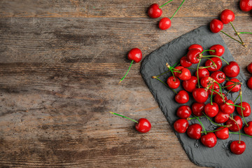 Sweet red cherries on slate plate, top view