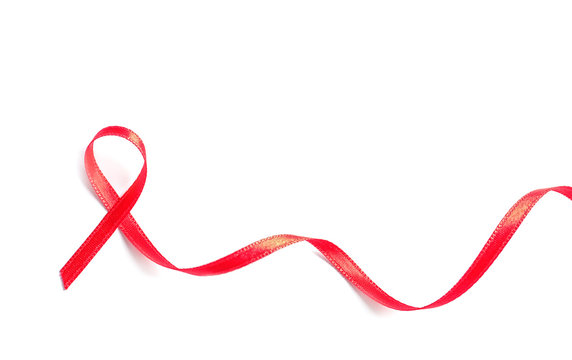 Red ribbon on white background, top view. Cancer awareness