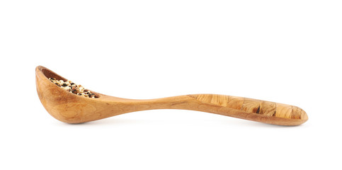 Wooden spoon of quinoa seeds isolated