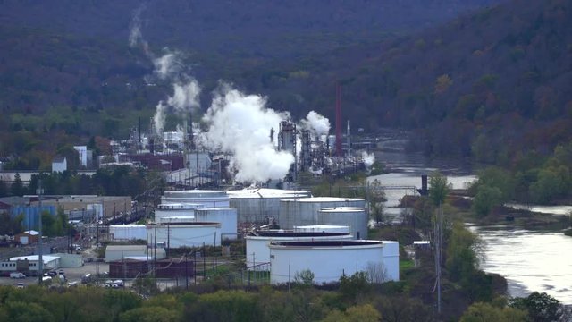 Riverside smoking oil refinery plant scenery - United States