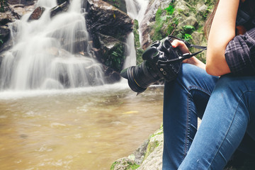 Close up of woman photographer with camera in the beautiful nature