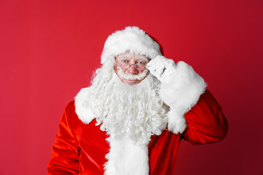 Portrait of authentic Santa Claus on color background