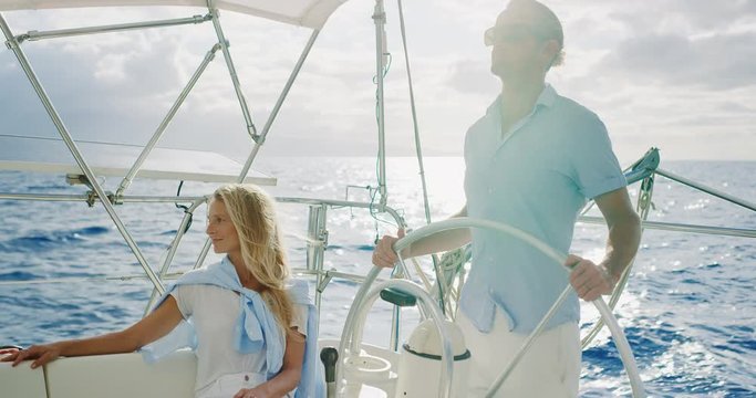 Attractive couple enjoying beautiful day sailing