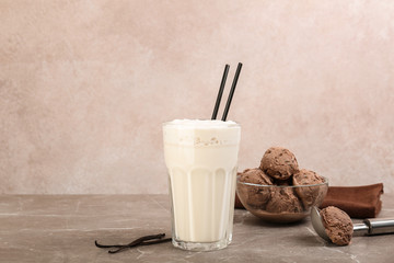 Glass with delicious milk shake on table