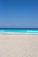 A pristine turquoise sandy beach background with lots of copy space. Useful for design