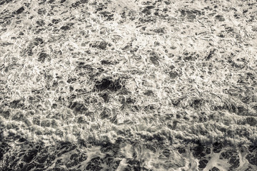 Strong sea waves crashing ashore with lots of foam. Useful for a background image.