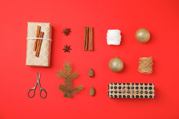 Flat lay Christmas composition with gift boxes and festive decor on color background