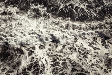 Strong sea waves crashing ashore with lots of foam. Useful for a background image.