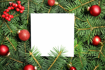 Blank paper sheet with Christmas decoration on fir tree branches as background