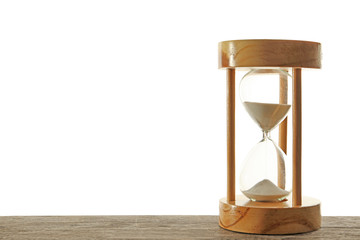 Hourglass with flowing sand on table against light background. Time management
