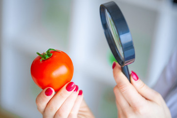 Diet. Doctor Nutritionist hold tomato in her office. Concept of natural food and healthy lifestyle....