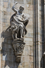 Fototapeta premium Sculptures of saints and martyrs decorating the Cathedral of Milan (Duomo di Milano) are shot close-up. 