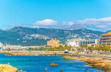 Beach at Palma de Mallorca with the cathedral at background, Spain © dudlajzov