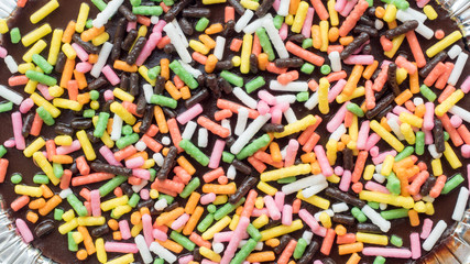 Fototapeta na wymiar cake chocolate with rainbow close up on white background