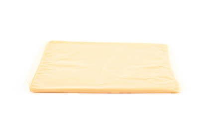 Slice of processed cheese isolated